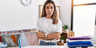 angry upset wife fed up while doing laundry