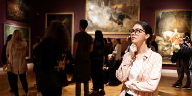 woman looking at art in museum
