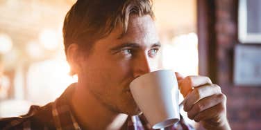 Man drinking coffee enjoying the benefit of living longer
