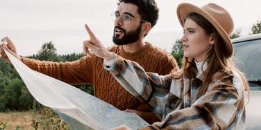 couple with no sense of direction trying to navigate from a map