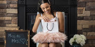 Bride opening gifts at shower that bridesmaid got a surprise invoice for