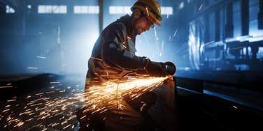 Worker cuts steel.