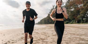 couple running together on the beach