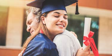 dad hugging his daughter on her graduation day