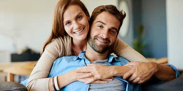 happy couple hugging on the couch