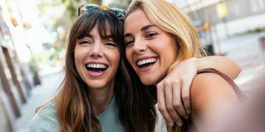 Two women look at the camera.
