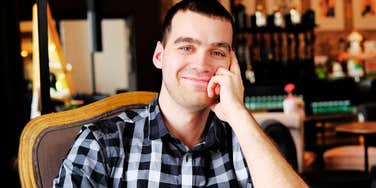 Man with a slightly cruel, happy grin.