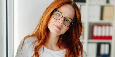brilliant woman standing in her office