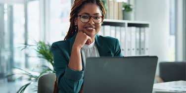 woman slipping insults into work emails while smiling