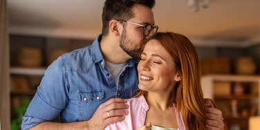 man lovingly kissing the head of the woman he loves
