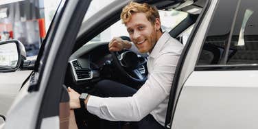 gen z man sitting in baby boomer's car