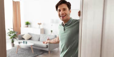 loyal man opening the door to his home to woman