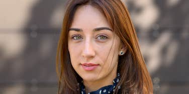 serious woman who grew up poor being frugal