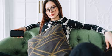 intelligent woman trying to relax on her couch