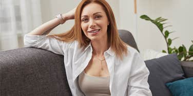 rich woman sitting on her couch