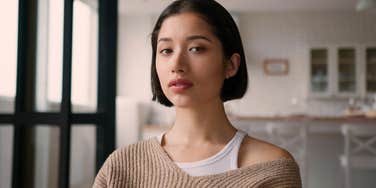 young woman unequipped for adulthood sitting in her kitchen