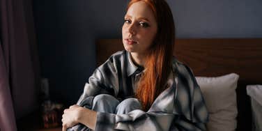 burned out woman trying to relax in bed