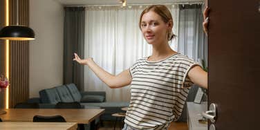 frugal woman welcoming guests into her home