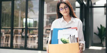 woman walking out of office after resigning