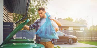 man throwing out trash to avoid paying extra fine