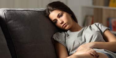 anxious adult sitting on couch