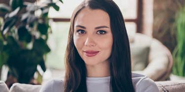 smiling young woman appearing generous but actually being cheap