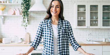 happy frugal woman standing in her kitchen
