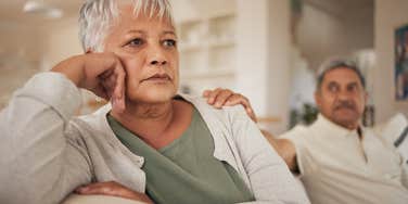 older couple struggling in their marriage sitting on the couch