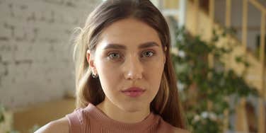 frugal woman afraid of being poor again looking sad