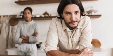 couple preparing dinner man looking uninterested in wife