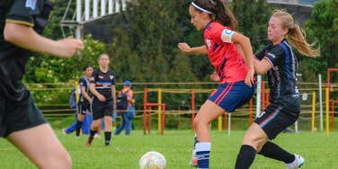 teen girls playing soccer