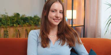 woman raised around money judging from her couch