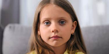 deeply unhappy child looking sad