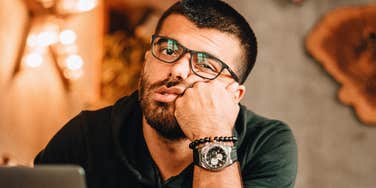 Deeply miserable man having a conversation. 