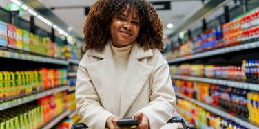 frugal woman smiling shopping at the grocery store