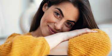 introverted woman smiling comfortably at home