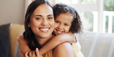 stay at home mom hugging her daughter