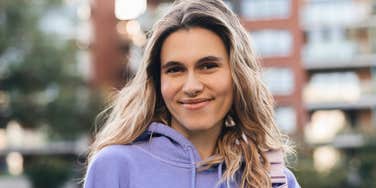 woman who grew up rich smiling happily