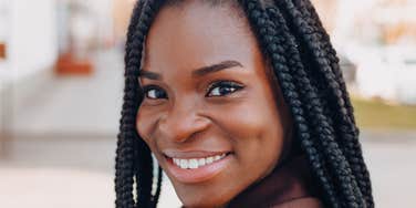 unmarried woman smiling thinking about her life