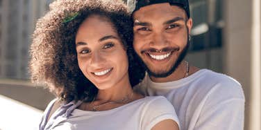 happy couple smiling snuggling close