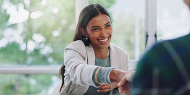 employee shaking employer's hand during job interview