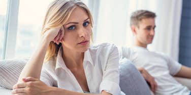 upset wife turned away from husband on couch