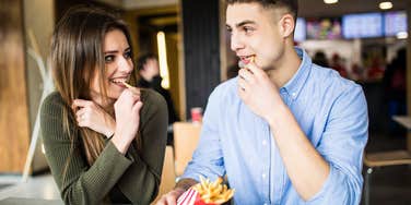 couple sharing fries on a date