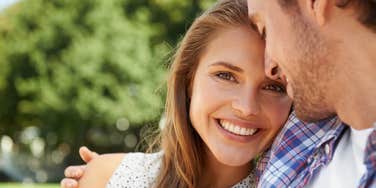 woman smiling hugging husband