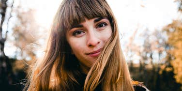 Woman practicing forgiveness, releasing bitterness. 