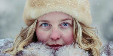 Woman keeps cozy while weather gets cold.