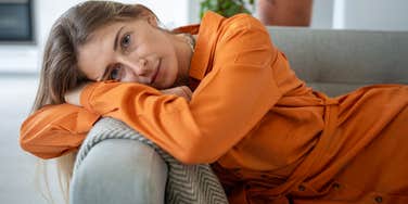 exhausted woman on her couch unable to set boundaries