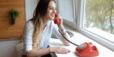 woman using an old rotary phone