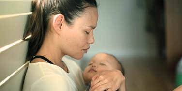 Heroic mom handles her sadness when things go wrong while cradling baby