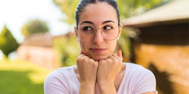 millennial woman pretending to be rich looking suspicious